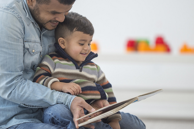 A dad reading to his young son