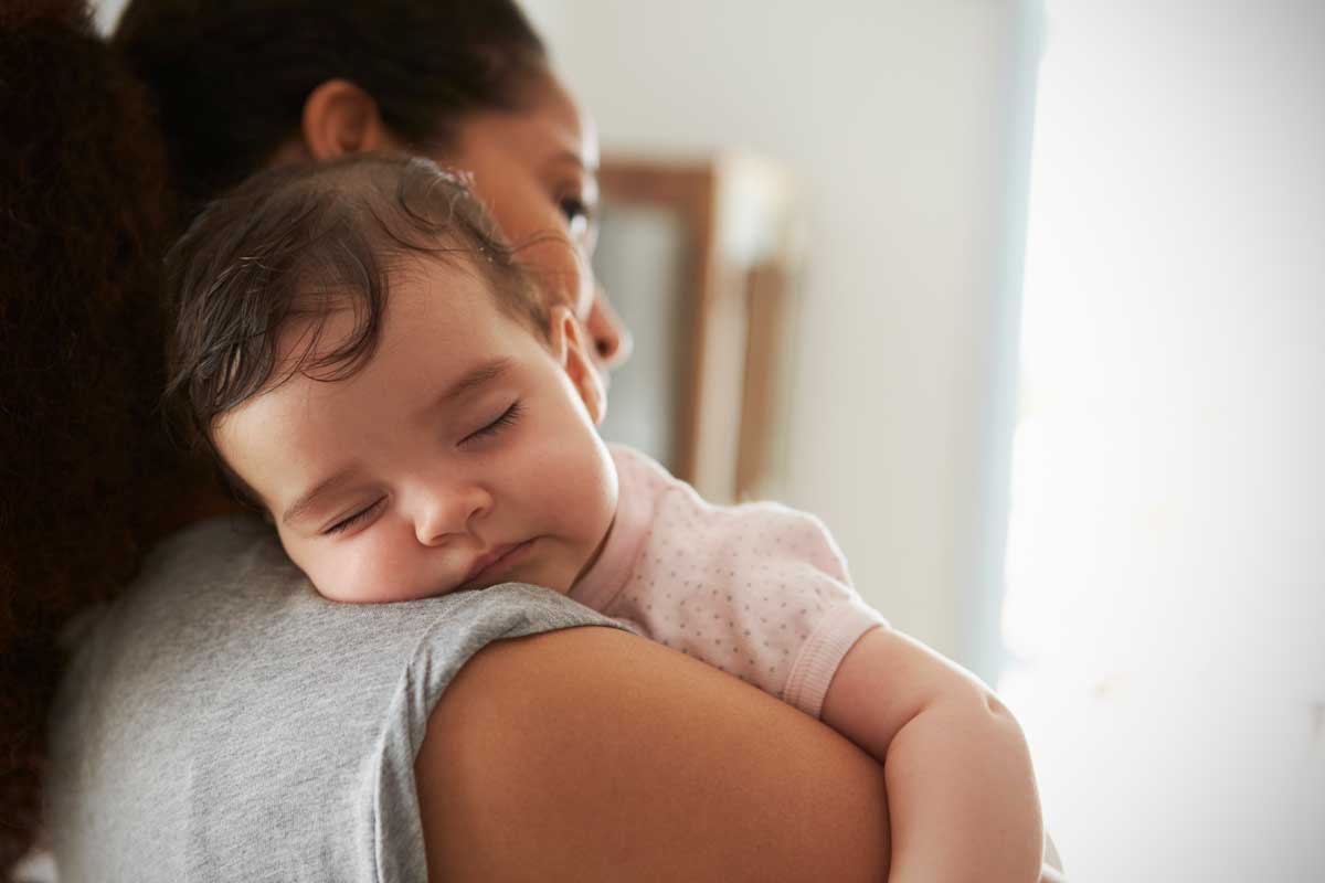 Mother holding sleeping child